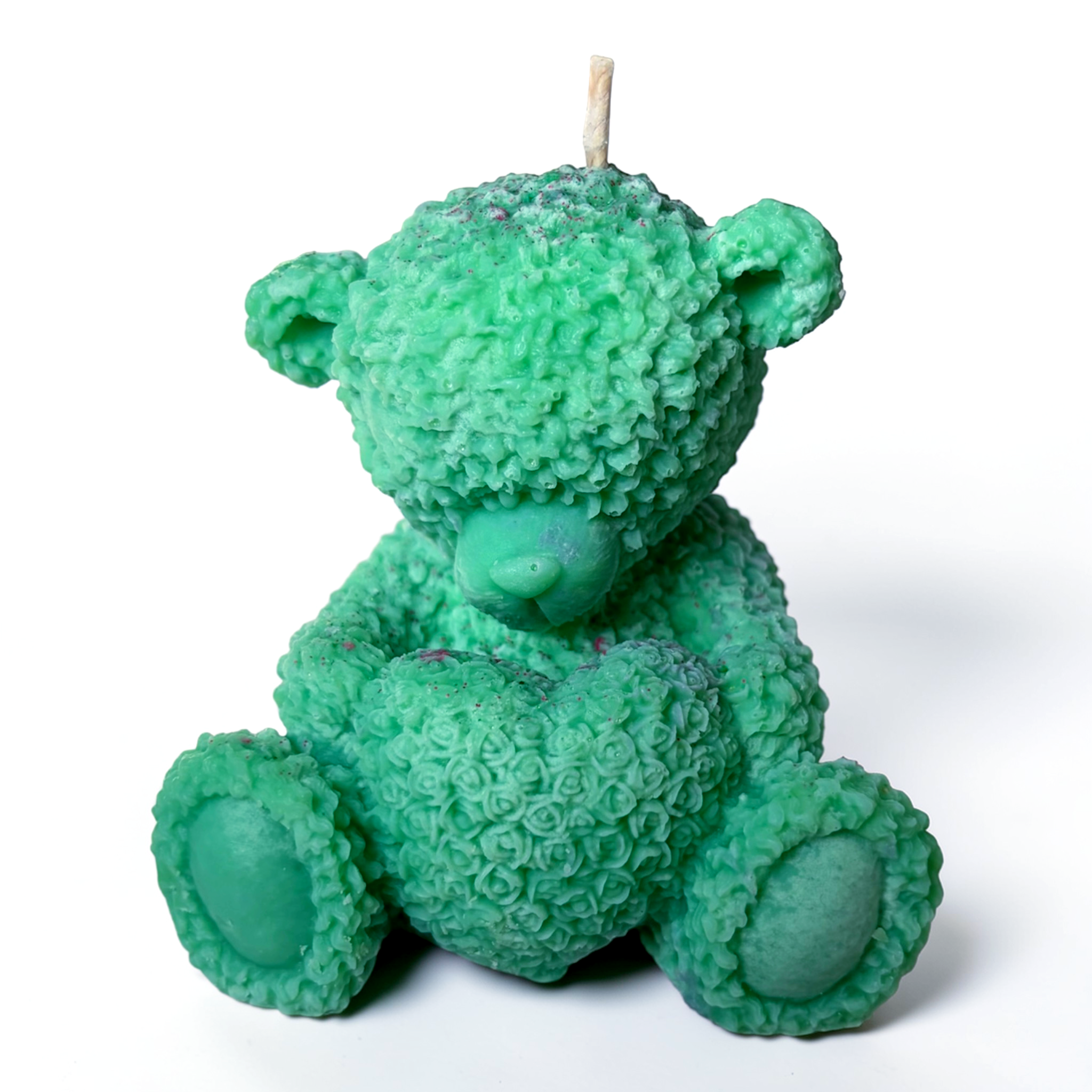 Teddy bear holding a heart decorative candle